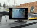 A 2011 Ford F-550 with a dashboard display showing a view of the road ahead