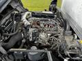 A 2018 Hino 195 engine with various pipes wires and components visible including a turbocharger and fuel injectors