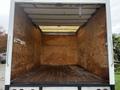 Interior of a 2012 Mitsubishi Fuso FE box truck showing wooden walls and flooring with no cargo present