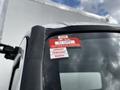A close-up of a 2019 Hino 195's windshield displaying a red certificate of approval sticker with the year 2026 and months January February March