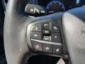 Steering wheel controls of a 2023 Ford Bronco Sport featuring buttons for cruise control and audio settings