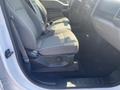 Interior view of a 2017 Ford F-150 showing front seats in light gray fabric with seat belts and armrest
