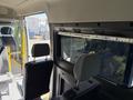 Interior view of a 2021 RAM Promaster with two front seats visible and a glass window in the back