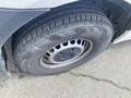 A close-up view of a tire from a 2022 Mercedes-Benz Sprinter featuring a silver rim and deep treads