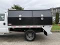 A 2016 Ford F-550 Super Duty with a black truck bed box featuring double doors and locks on the side
