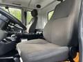Interior view of a 2012 Autocar Xpert featuring two fabric-covered seats with a driver's seat at the forefront and controls visible on the cabin floor