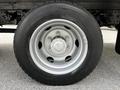 Close-up of a silver wheel and tire from a 2018 Hino 195 showcasing the tire tread and wheel rim design