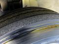 Close-up of the front tire of a 2021 Hino 338 showing tread patterns and the rim