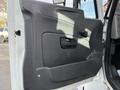 The interior door panel of a 2010 International 4300 featuring a sleek design with a smooth black surface and a door handle