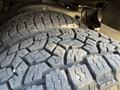 Close-up of two large, rugged tires with deep treads designed for heavy-duty performance