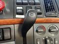 A close-up of the gearshift lever of a 2005 Volvo VND 122 showing the control handle with a symbol indicating the truck's powertrain status