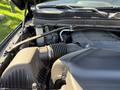 A close-up view of the engine compartment of a 2021 RAM 3500 showcasing various engine components and the intake system