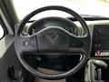 Steering wheel and dashboard controls of a 2019 International 4300 vehicle with various gauges and buttons displayed