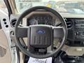 Steering wheel and dashboard of a 2008 Ford F-450 SD displaying gauges and controls