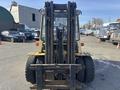 A 1993 Hyster H80XL forklift with a yellow and black color scheme, featuring large wheels and a prominent fork lift mechanism in the front