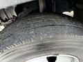 Close-up of a worn tire from a 2015 Mitsubishi Fuso FE showing visible tread wear and surface details
