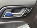 Close-up of the door handle and control panel of a 2016 Chevrolet Tahoe featuring a chrome handle and lock/unlock buttons