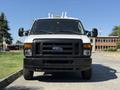 Front view of a white 2011 Ford Econoline van with a black grille and headlights positioned centrally