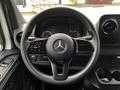 Steering wheel of a 2020 Mercedes-Benz Sprinter featuring the iconic logo and control buttons on the left side