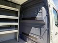 A 2019 Mercedes-Benz Sprinter cargo van with open shelving installed in the rear compartment