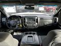 Interior view of a 2017 GMC Sierra 3500HD showing the dashboard center console and driver's seat with infotainment system and controls