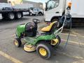 A 2021 John Deere L Series S lawn tractor with a yellow seat and green body equipped with a steering wheel and rear-mounted hose