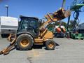 A 2008 Case Super 580M backhoe loader with a yellow and black exterior and a front loader attachment