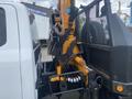 A 2017 Ford F-550 with a mounted hydraulic lift system featuring hoses and a control panel attached to the side of the vehicle
