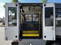 Interior of a 2019 Chevrolet Express showing an accessibility ramp in a lowered position with yellow safety rails and two seats visible inside the vehicle