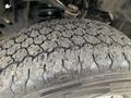 Close-up of a worn tire with a detailed tread pattern showing signs of use and dirt accumulation on a 2019 Ford F-150