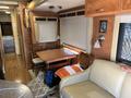 Interior of a 2008 Newmar Canyon Star 36 Foot Class A Motorhome featuring a dining table with four chairs and a beige sofa