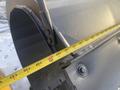 A close-up of a 2000 plow with a 12-foot attachment featuring a measuring tape indicating measurements along the edge of the plow