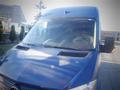 A blue 2017 Mercedes-Benz Sprinter van with a large front windshield and distinctive grille design