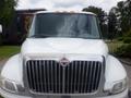 A front view of a white 2015 International 4400 truck featuring a large chrome grille and six orange marker lights on the roof