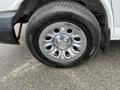 Close-up of a chrome wheel rim with a Chevrolet emblem and black tire labeled Michelin Defender LTX M/S