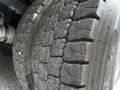 Close-up of a worn tire with deep tread pattern showing signs of use on a 2016 Ford F-550