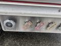 Silver control panel with labeled switches and a large black knob indicating master drain on a 2006 E-One Typhoon fire truck