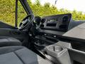 Interior view of a 2020 Mercedes-Benz Sprinter showing the driver's seat dashboard and console with audio system and cup holders
