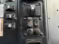 Control panel of a 2010 Autocar Xpeditor featuring various switches including interior lights wash and dim settings