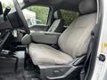 Interior of a 2020 Ford F-350 SD featuring a textured gray fabric driver's seat and armrest in the foreground
