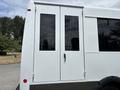 A white 2020 Chevrolet Express van with double doors on the side and large black windows