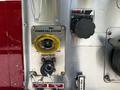 Close-up of a 2006 Emergency One Fire Truck control panel featuring a yellow foam inlet connection and various labeled switches and knobs for fire response systems