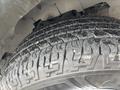 Close-up of a tire from a 2022 GMC Savana showcasing the tread pattern and details of the rubber surface