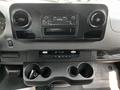 Interior dashboard of a 2019 Mercedes-Benz Sprinter with a radio display and cup holders