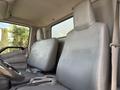 Two gray vinyl seats in the cabin of a 2014 Hino 195 truck with a simple design and no visible seatbelts