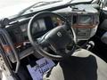 Interior of a 2005 Volvo VND 122 featuring a steering wheel dashboard controls and a gear shift with a floor mat displaying a thank you message