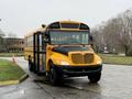 A yellow and black 2013 International 3000 school bus with a prominent front grille and large windows