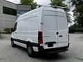 A white 2020 Mercedes-Benz Sprinter van parked with a rear view showing its sleek design and roof rack