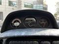 Dashboard of a 2003 Mitsubishi Delica showing temperature, outside temperature reading 20 and fuel gauge with various indicators