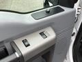 Detail of a 2016 Ford F-350 SD door panel featuring power window controls and a lock switch